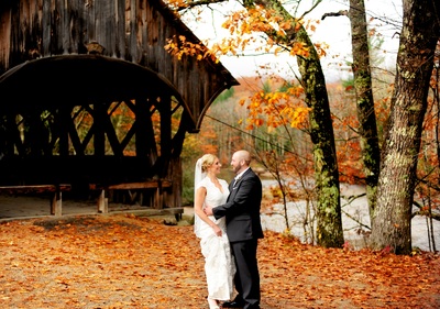 autumn wedding photos by covered bridge in maine